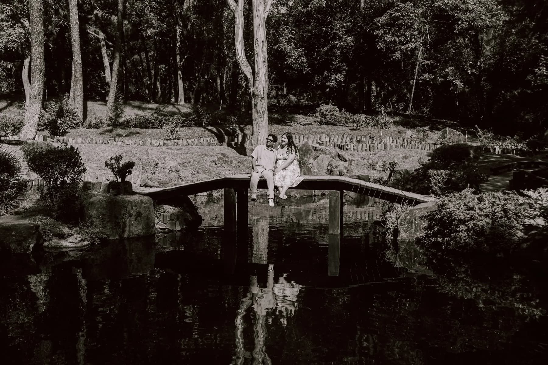 A black and white photograph of us on the bridge over the pond
