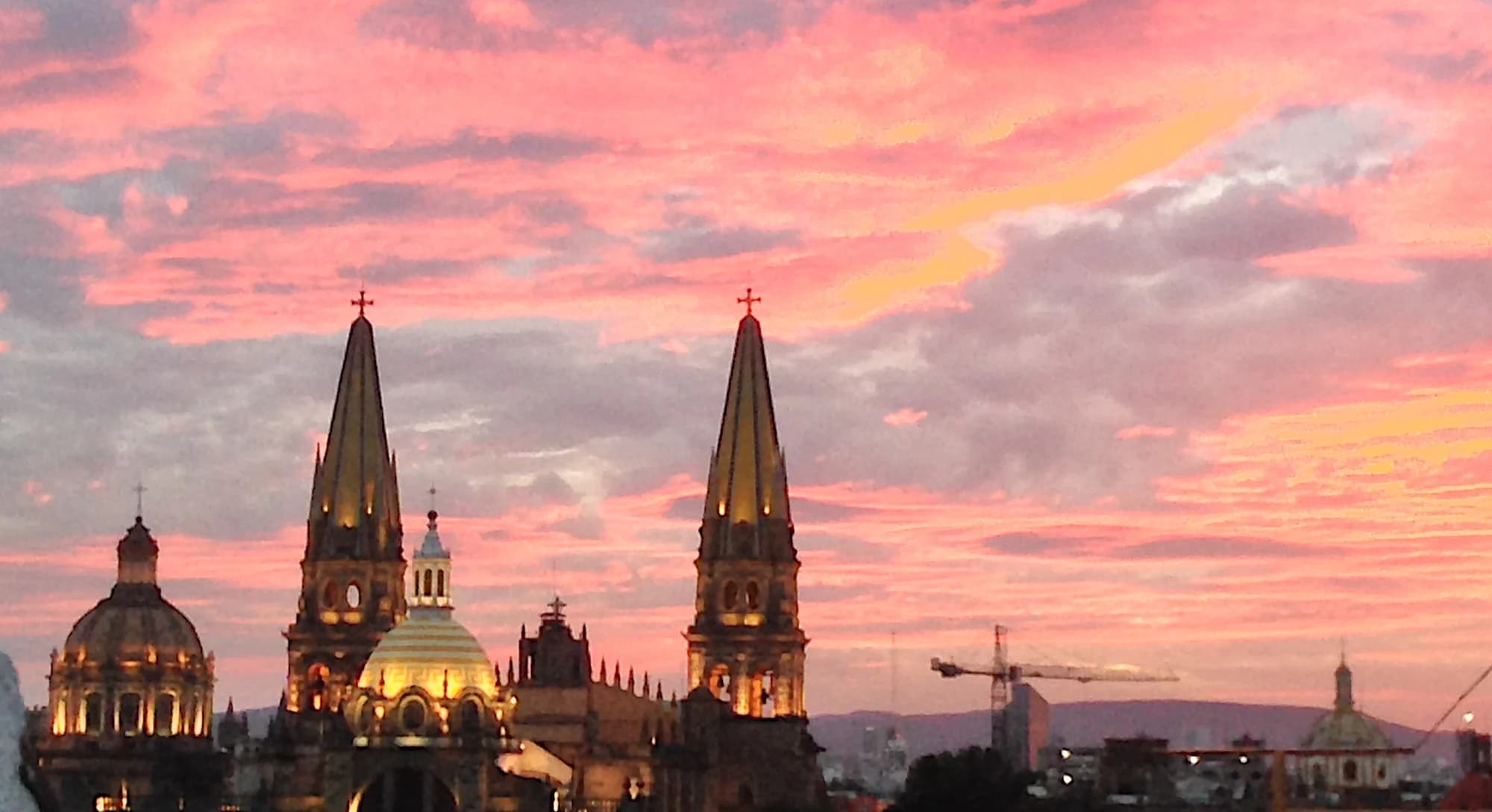 Cathedral towers beneath a coral and gold sunset
